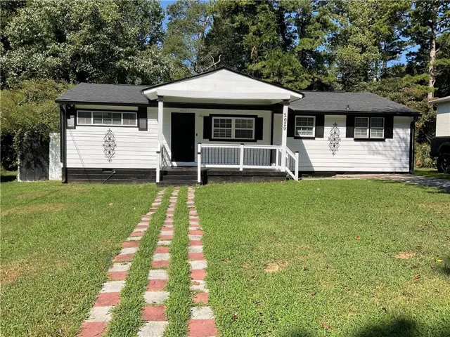 White siding exterior with a dark roof