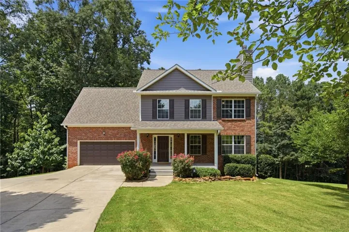 Traditional-style home featuring a brick and siding exterior with a covered front porch