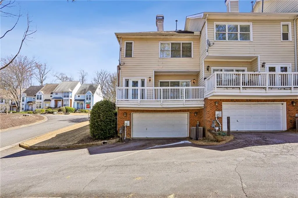 Back of property with two car garage