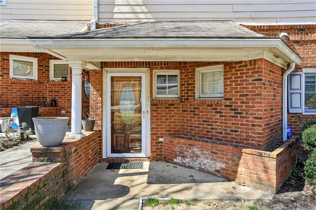 Entrance to property with brick siding