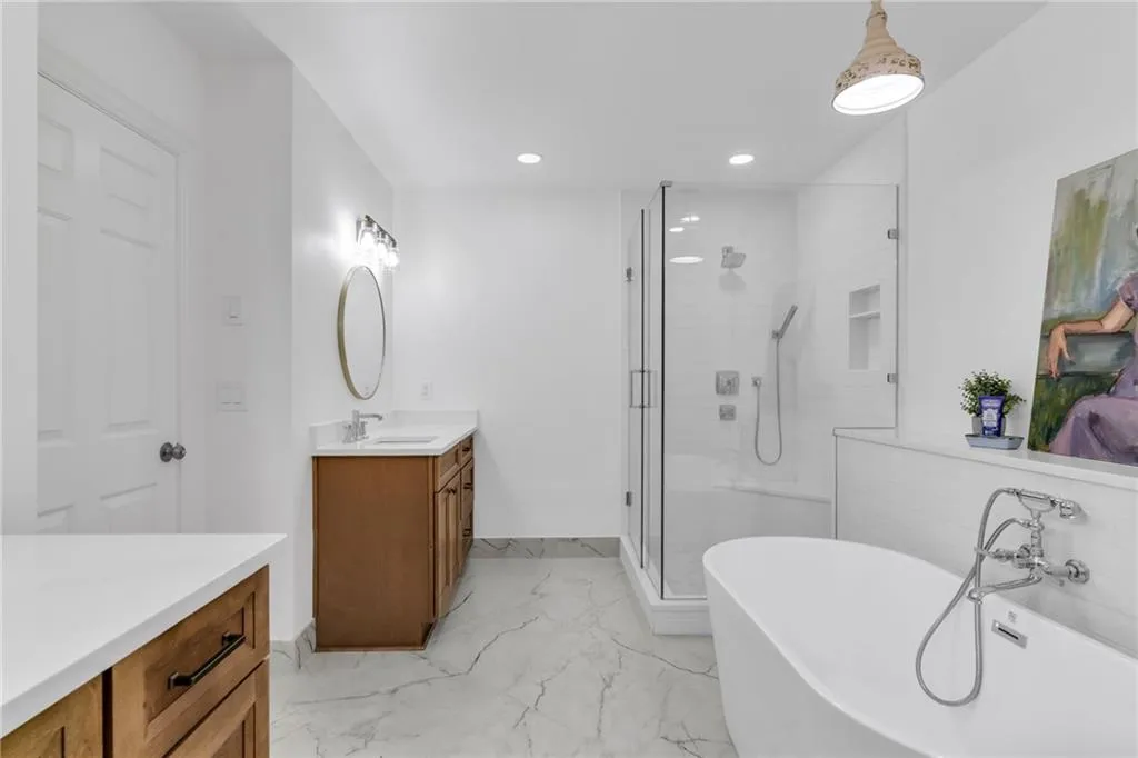 Primary bathroom has double vanities and stand alone shower.