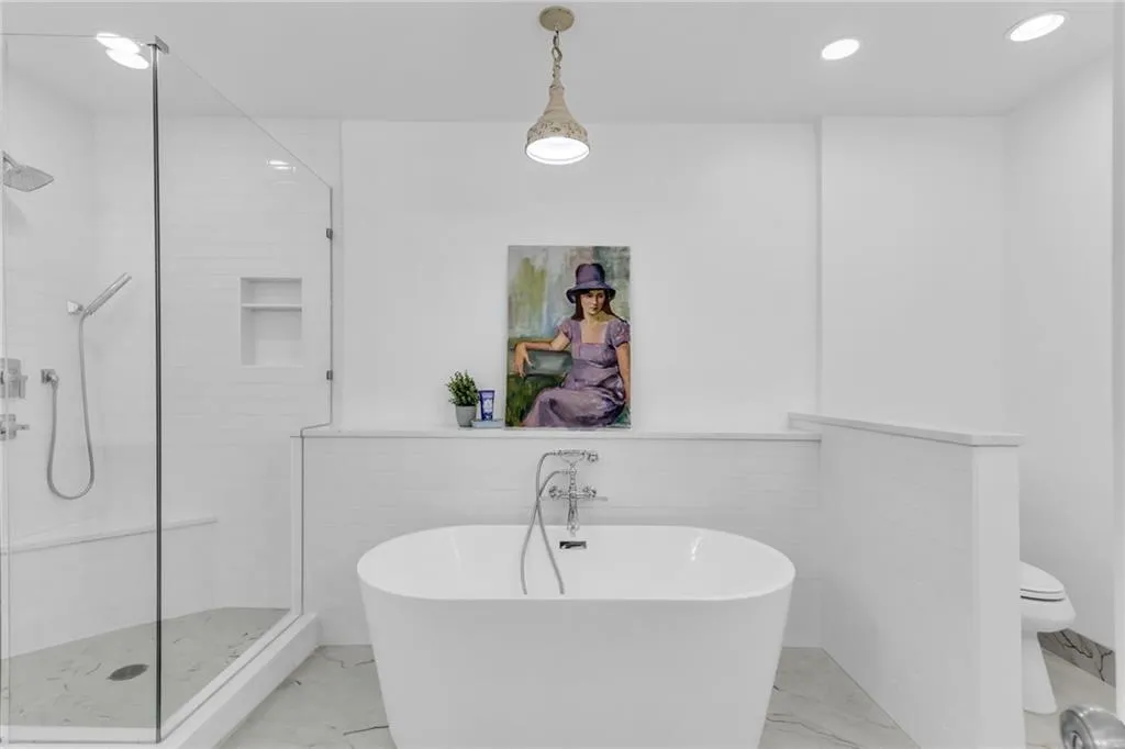 Primary bathroom includes a sleek soaker tub