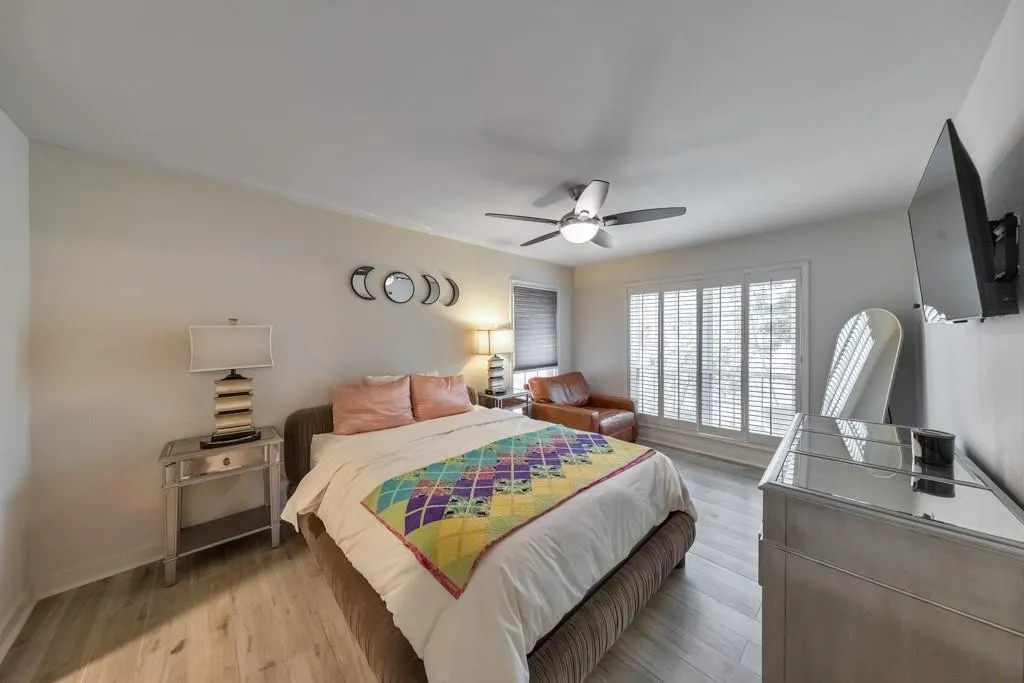 SPACIOUS PRIMARY SUITE WITH WINDOWS AND PLANTATION SHUTTERS!