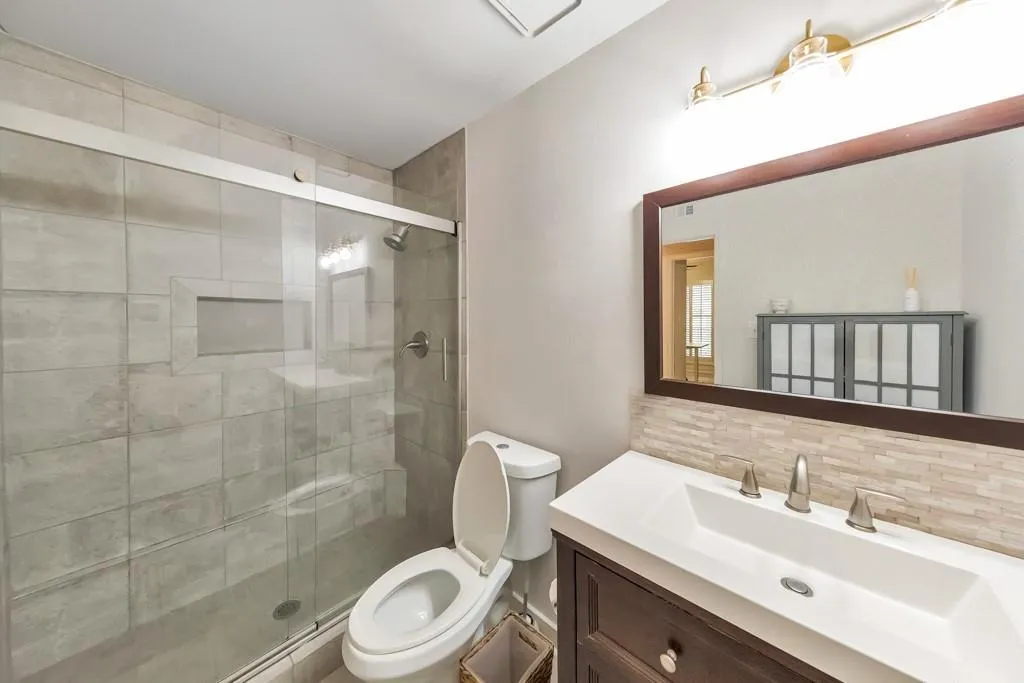 BEAUTIFUL TILED DOUBLE SHOWER IN THE BATHROOM WITH NEWER VANITY AND LIGHTING!