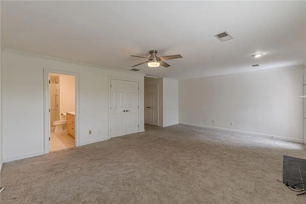 Spacious bedroom with fireplace and private deck access.