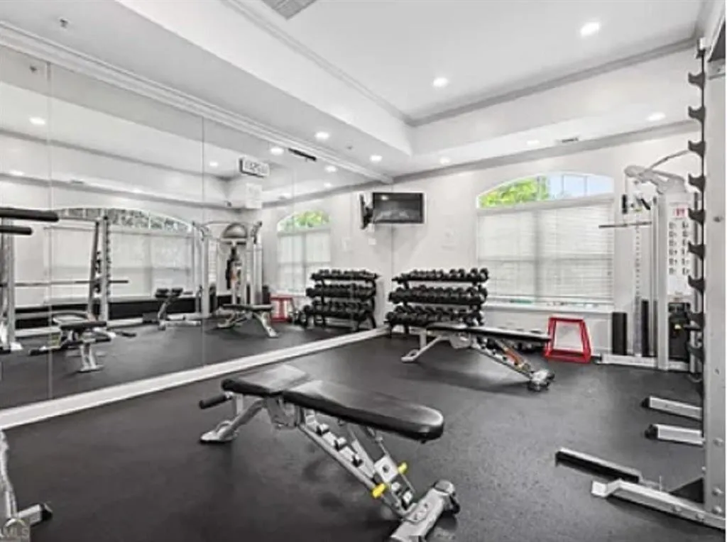 Workout area with crown molding and recessed lighting