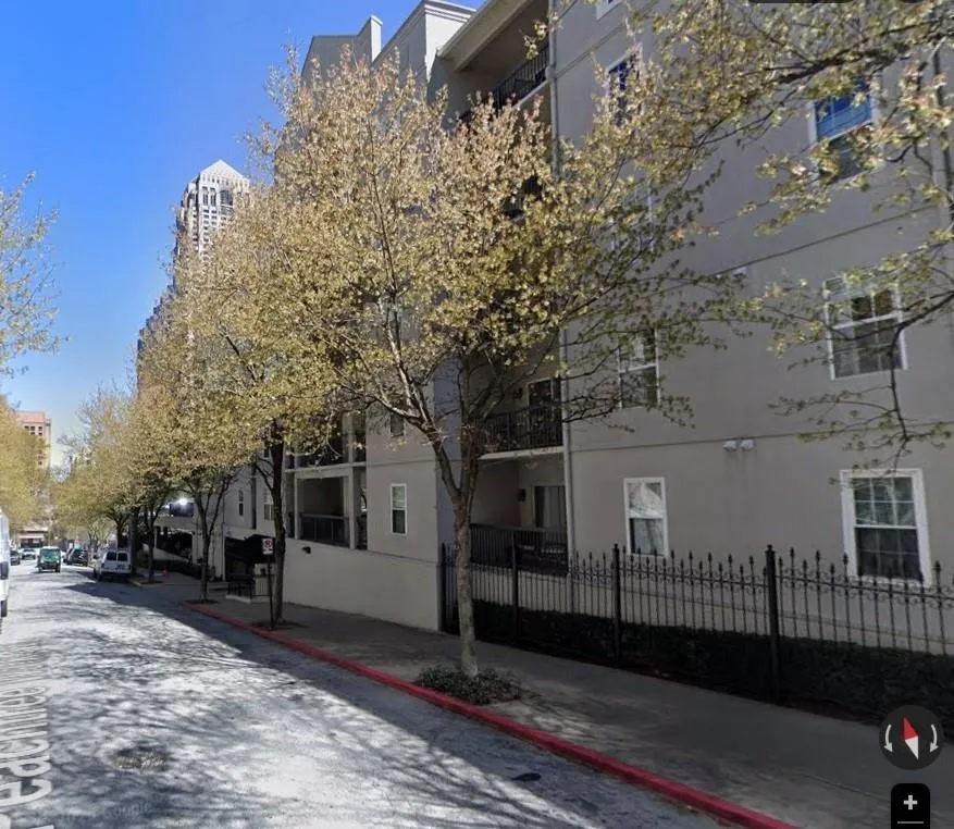 View of asphalt street with curbs and sidewalks