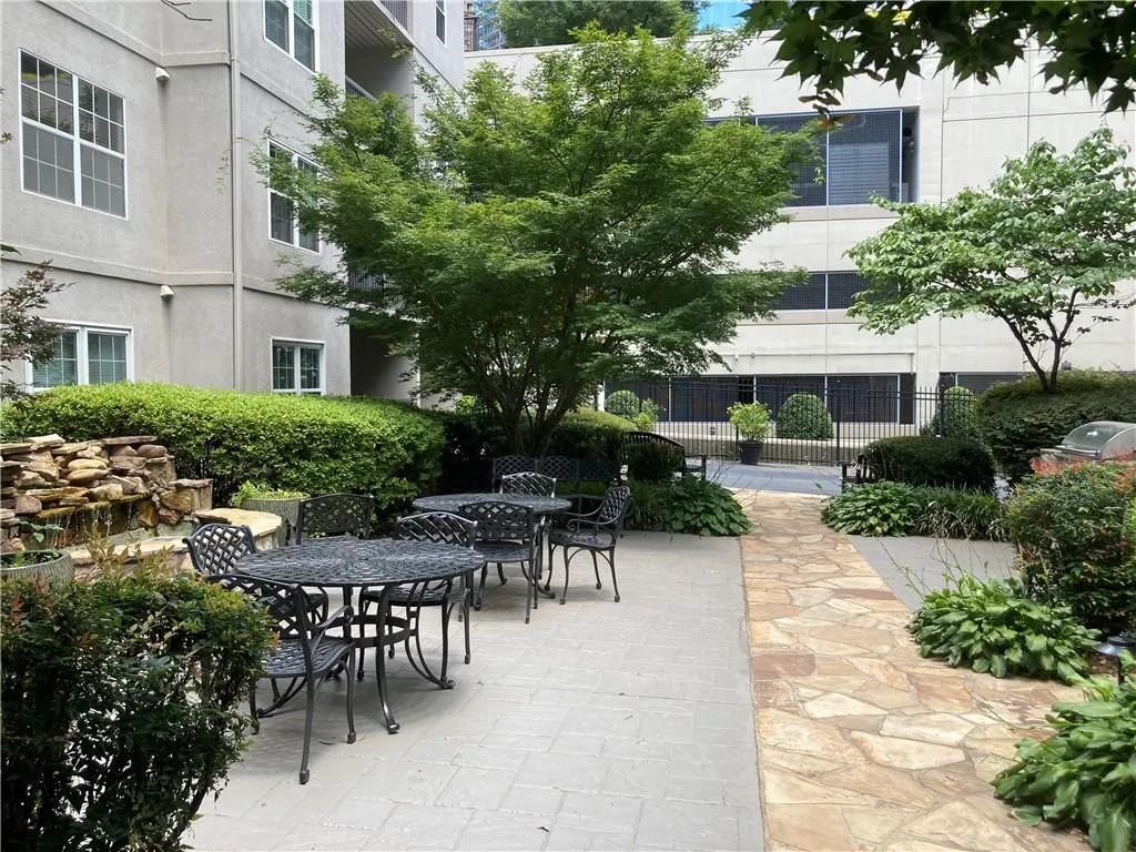 View of home's community with outdoor dining area and a patio