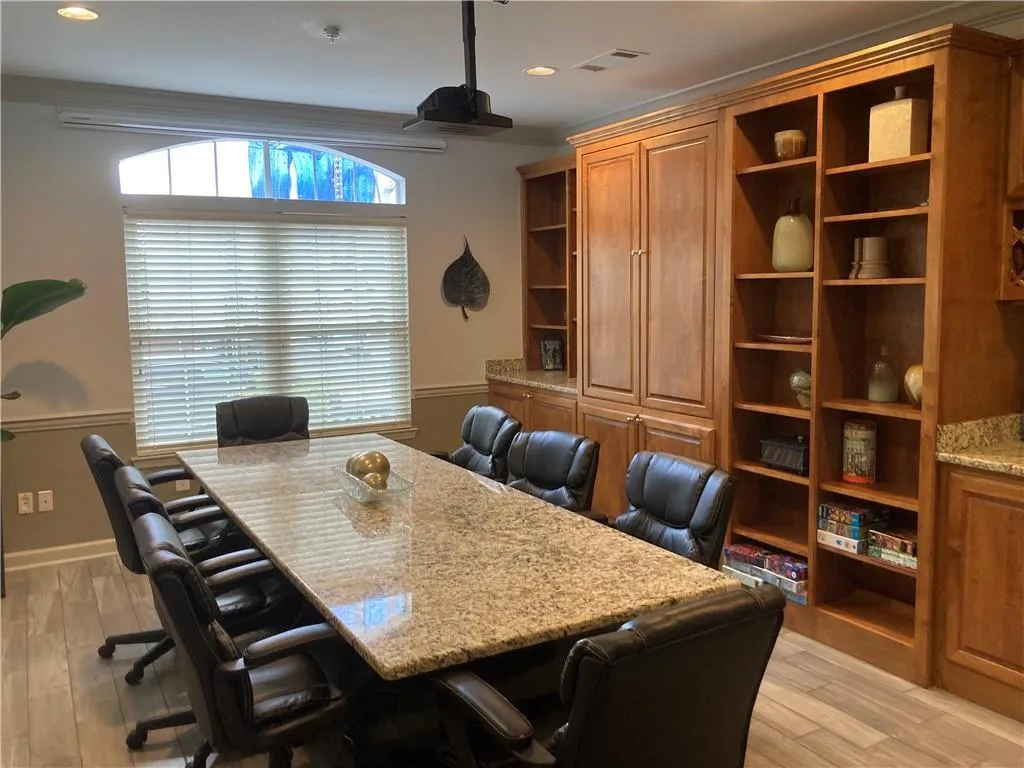 Office space featuring light wood-style floors and recessed lighting