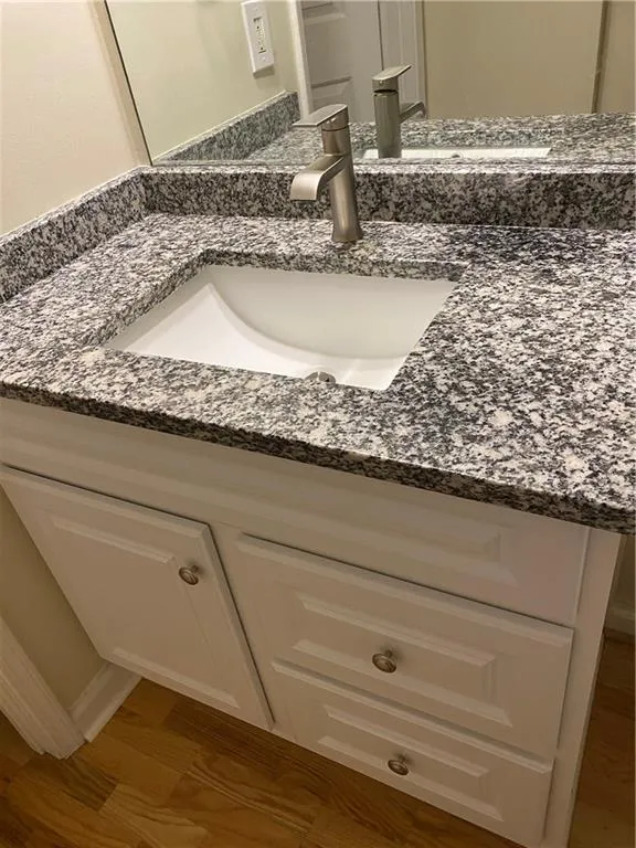 Bathroom view of vanity and wood finished floors