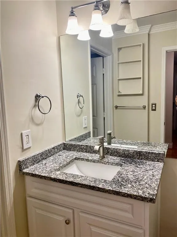 Bathroom featuring vanity and ornamental molding