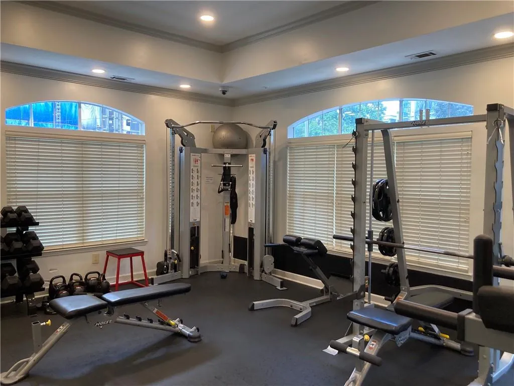 Exercise room with ornamental molding and recessed lighting