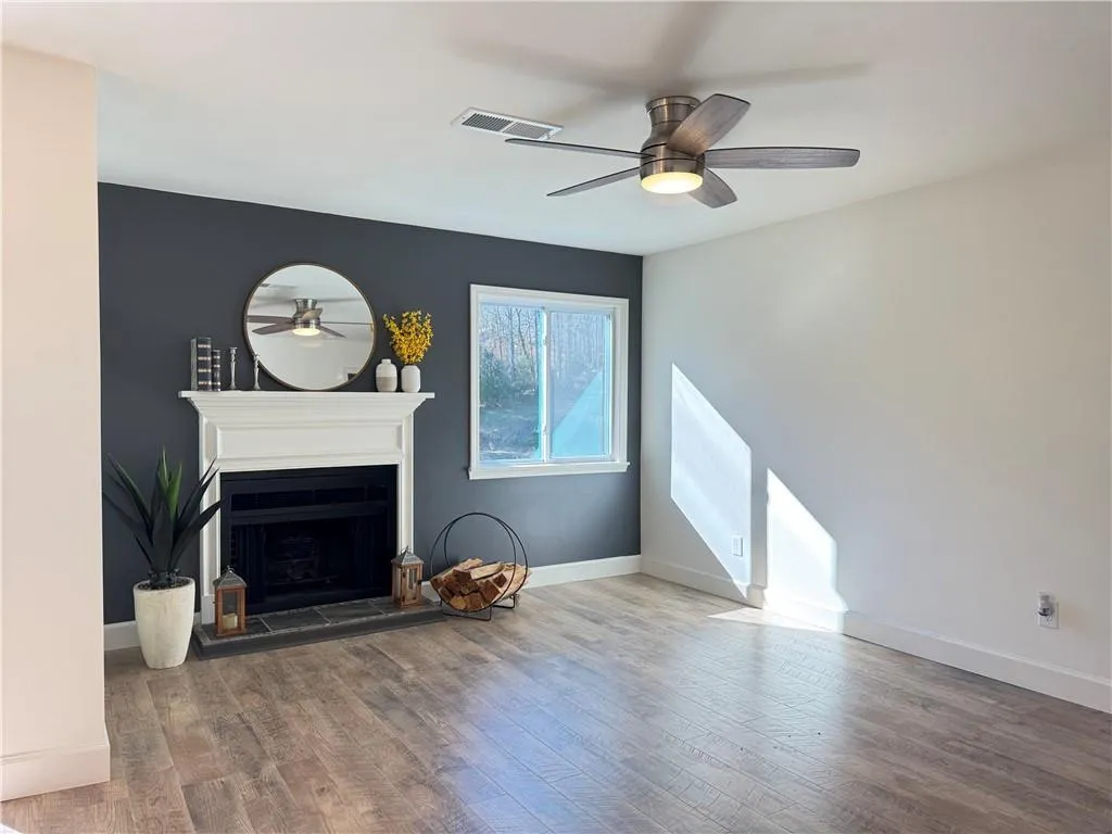 Living room with luxury vinyl floring, fireplace and ceiling fan