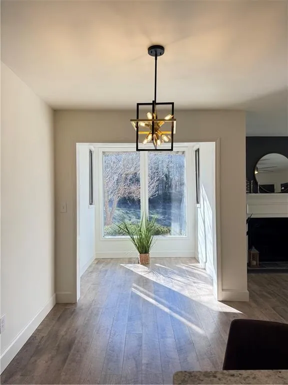 Dining area featuring dark hardwood / wood-style flooring and an inviting chandelier
