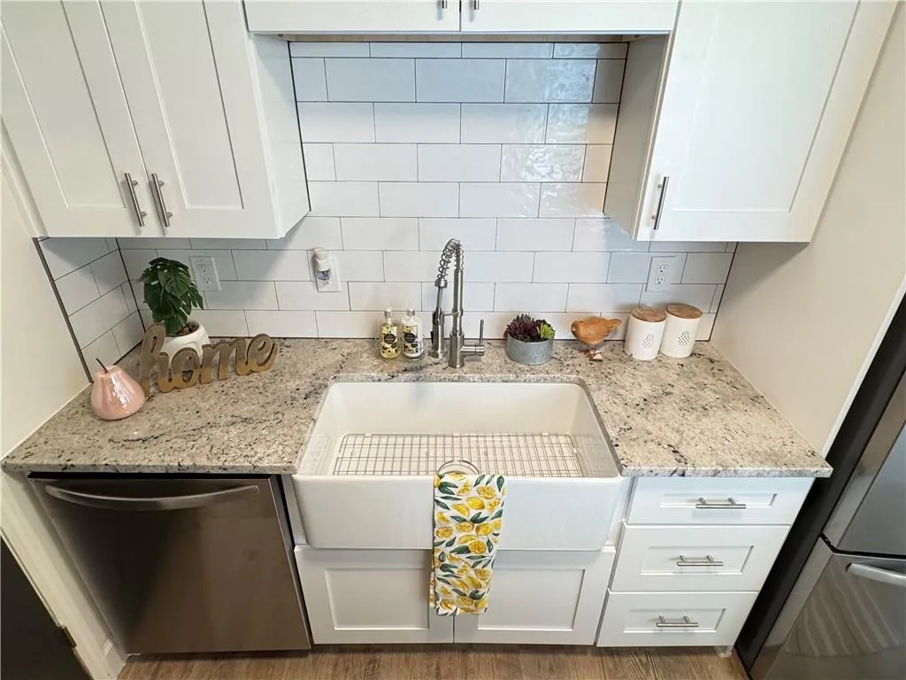 Clothes washing area featuring washer hookup, electric dryer hookup, and wood-type flooring