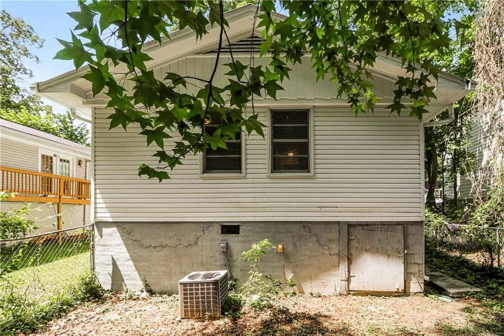 View of side of home with a cooling unit and crawl space
