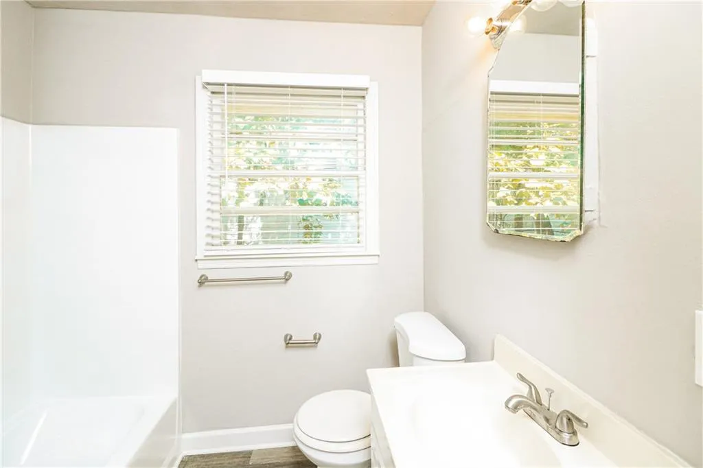Full bathroom with plenty of natural light and vanity