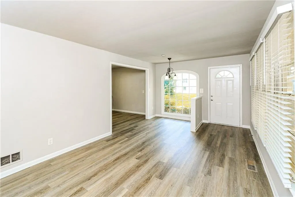Foyer with wood finished floors and baseboards