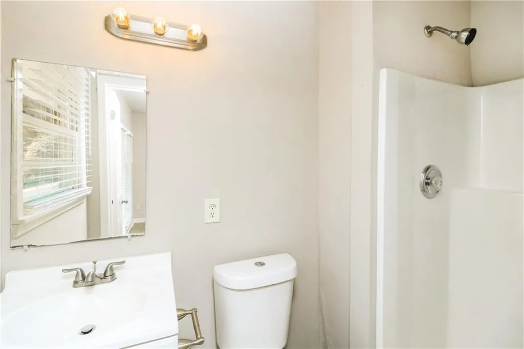 Bathroom featuring a shower and vanity