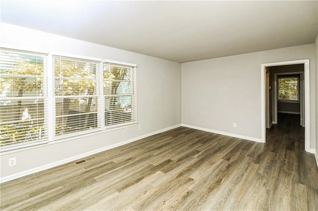 Unfurnished room featuring wood finished floors and baseboards