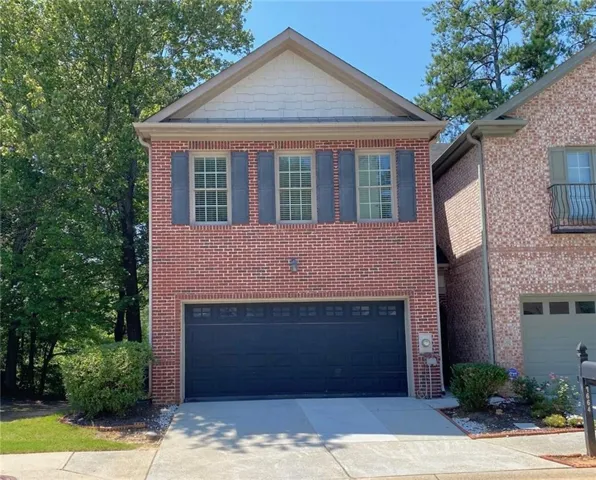 Brick exterior with a prominent two-car garage