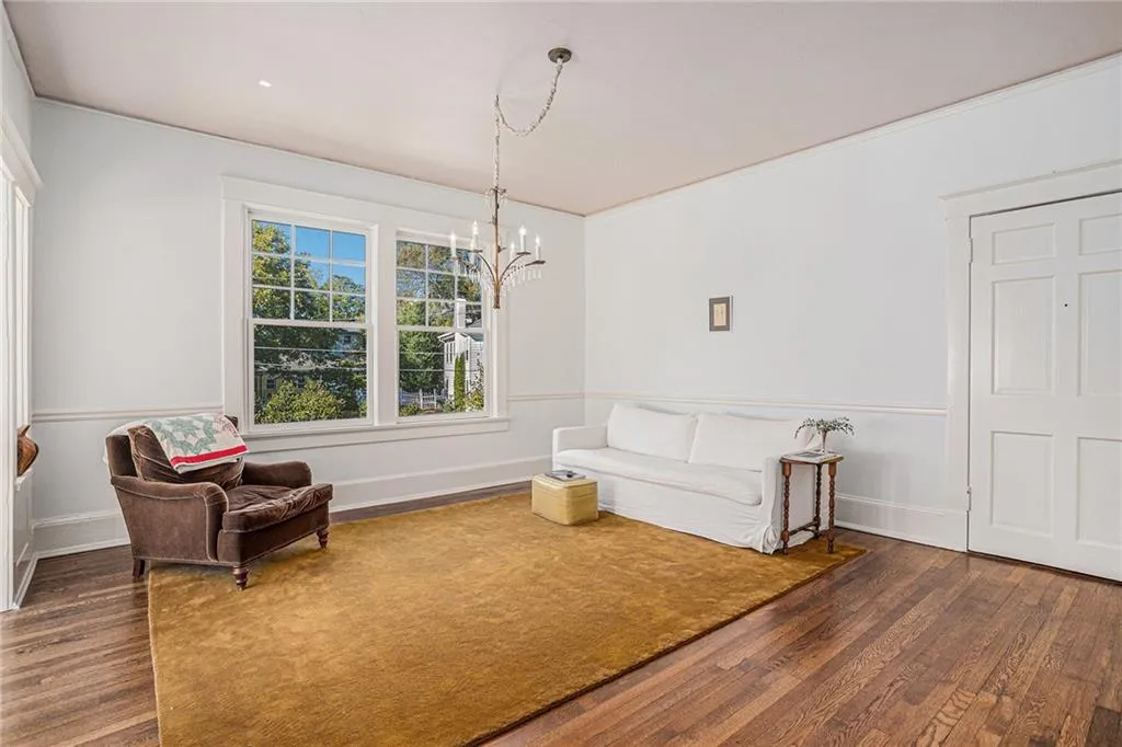 Sitting room with an inviting chandelier and dark hardwood / wood-style flooring