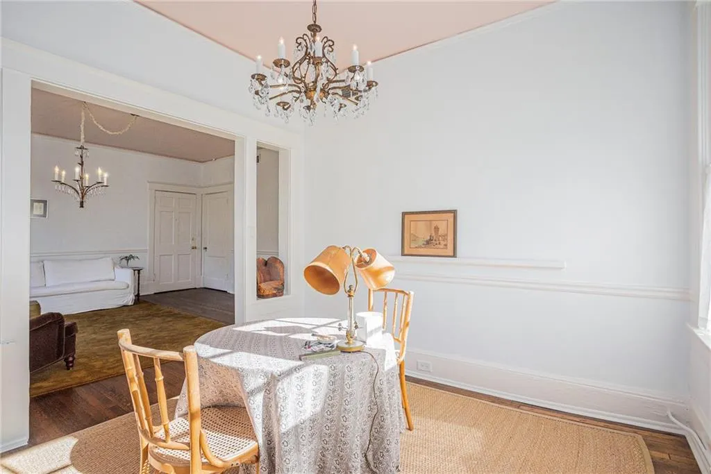 Dining space featuring wood-type flooring and a chandelier