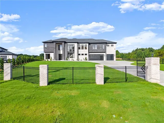 View of front of house with concrete driveway and an attached garage