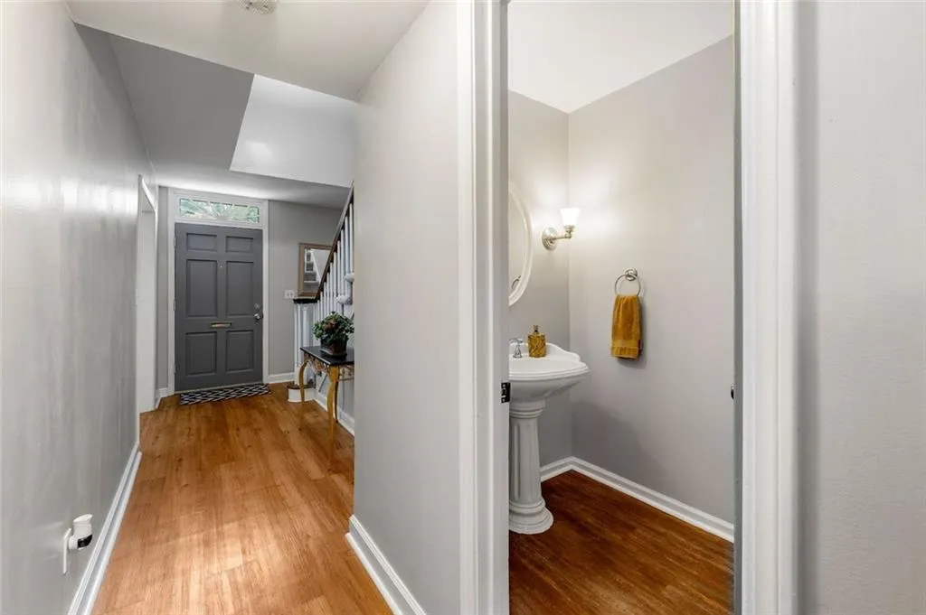 Hall featuring light hardwood / wood-style floors and sink Hall featuring light hardwood / wood-style floors and sink