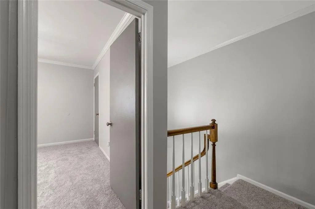 Hall featuring carpet flooring and crown molding Hall featuring carpet flooring and crown molding