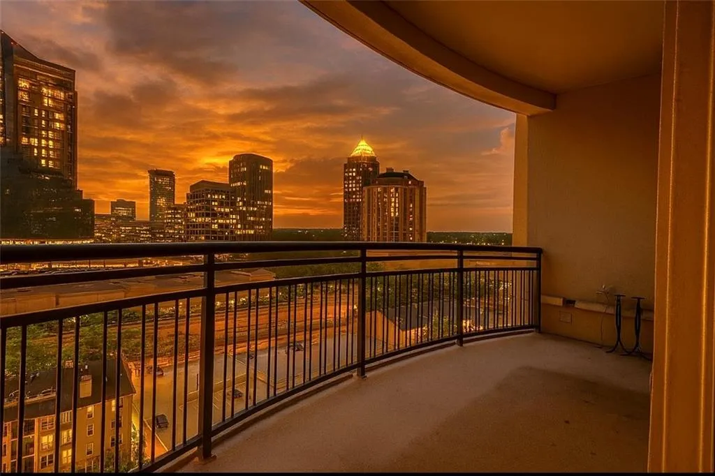 Balcony at dusk featuring a skyline view