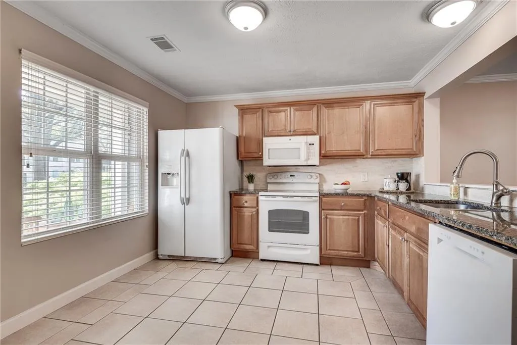 As you make your way through the front door, you’re greeted by an updated eat-in kitchen to your left, which features granite counters, custom cabinets, tiled backsplash, a pantry with plenty of storage, and a cozy breakfast nook. As you make your way through the front door, you’re greeted by an updated eat-in kitchen to your left, which features granite counters, custom cabinets, tiled backsplash, a pantry with plenty of storage, and a cozy breakfast nook.