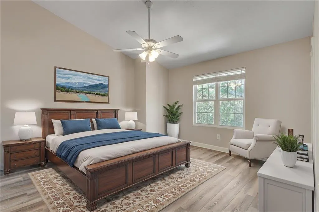 Virtually staged- Oversized primary suite with vaulted ceiling, walk-in closet, and ensuite bathroom Virtually staged- Oversized primary suite with vaulted ceiling, walk-in closet, and ensuite bathroom