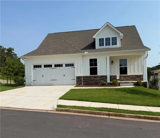 White board-and-batten siding with stone veneer accents