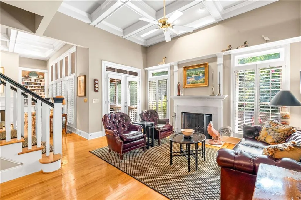 Family / keeping room boasts French doors to the screen porch, a wood burning fireplace with gas starter, and 11 foot coffered ceilings