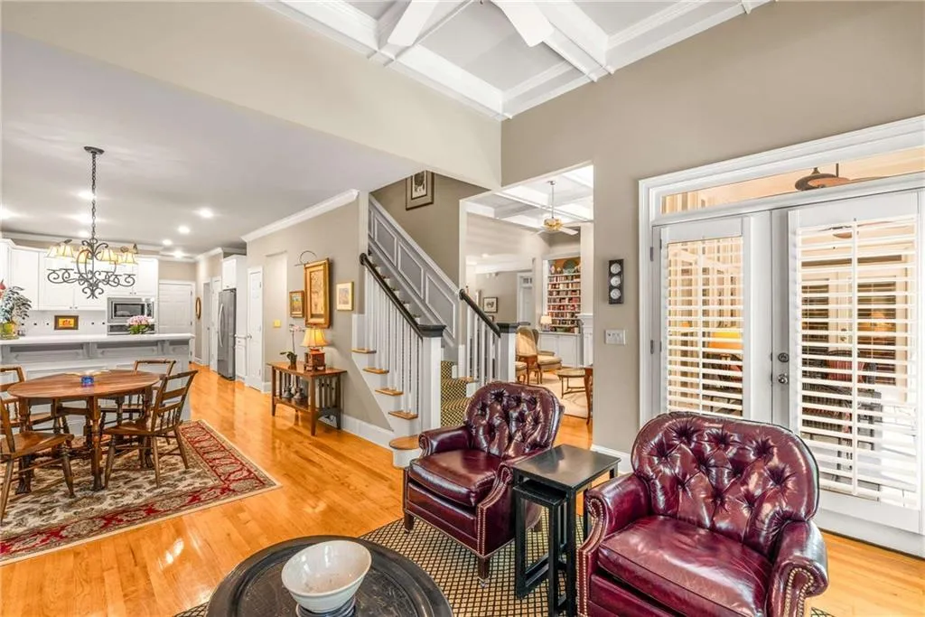 Family / keeping room boasts French doors to the screen porch, a wood burning fireplace with gas starter, and 11 foot coffered ceilings