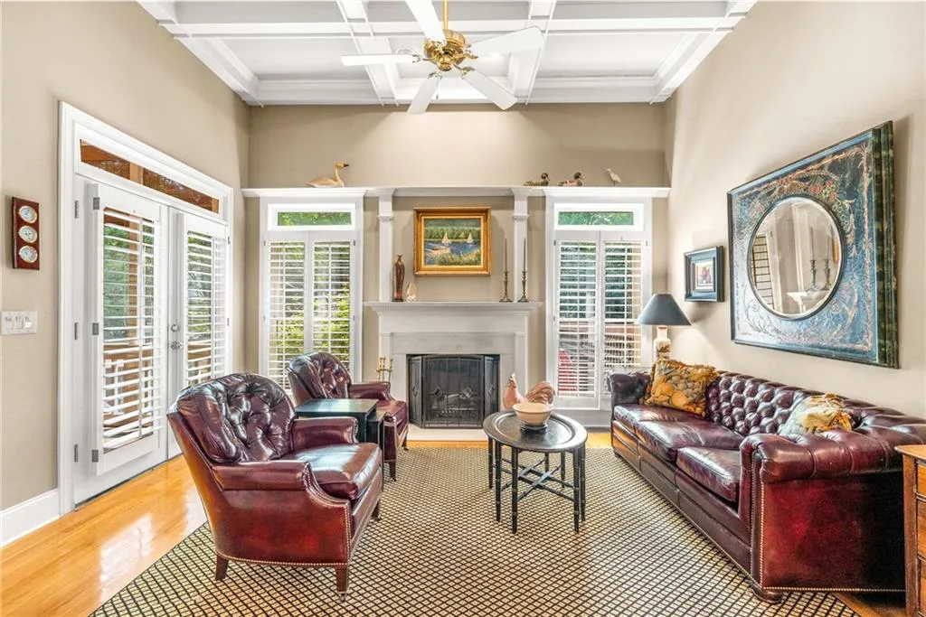 Family / keeping room boasts French doors to the screen porch, a wood burning fireplace with gas starter, and 11 foot coffered ceilings