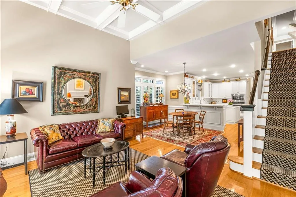 Family / keeping room boasts French doors to the screen porch, a wood burning fireplace with gas starter, and 11 foot coffered ceilings