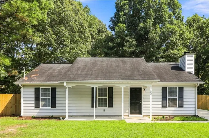 White siding exterior with a covered front porch and dark front door