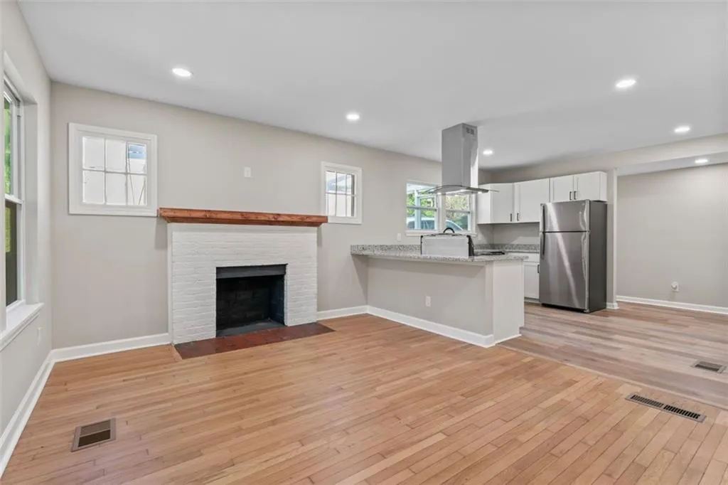Kitchen view to living room with recessed lighting and open floorplan