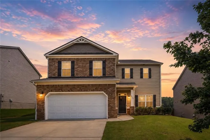 Brick two-story colonial with distinctive gabled roofline and architectural detailing