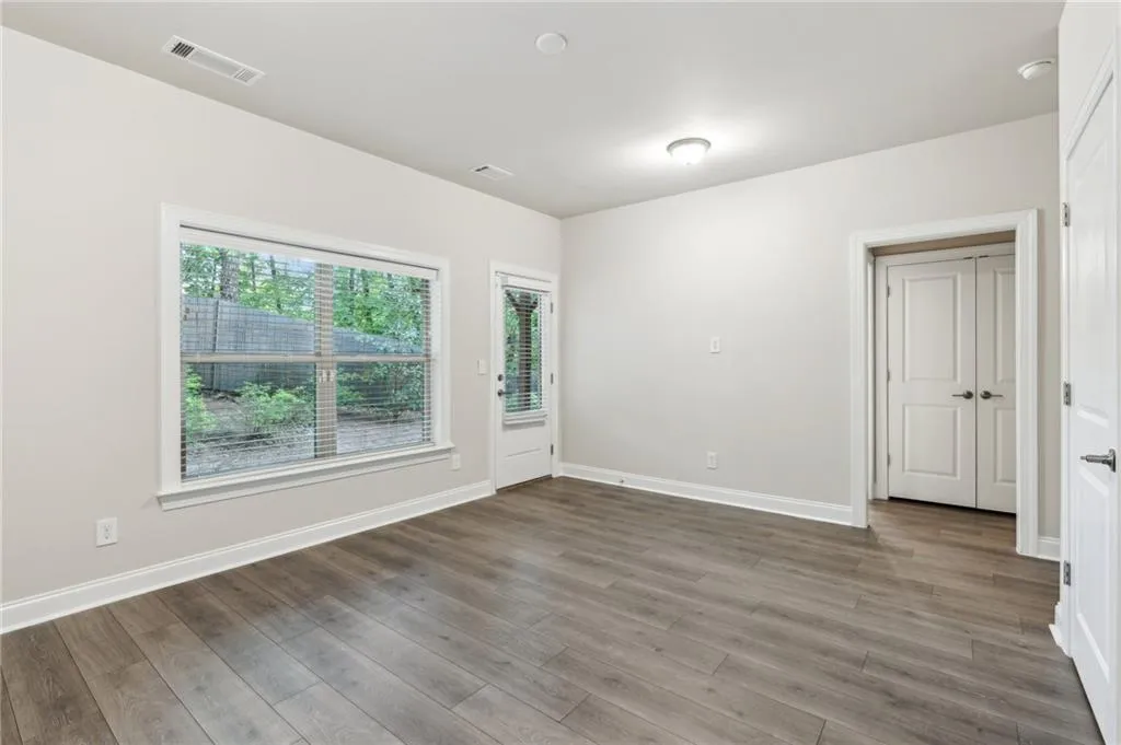 Empty room featuring wood finished floors and baseboards