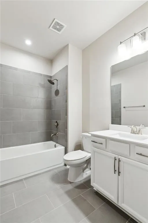 Full bath featuring vanity,  shower combination, and tile patterned floors
