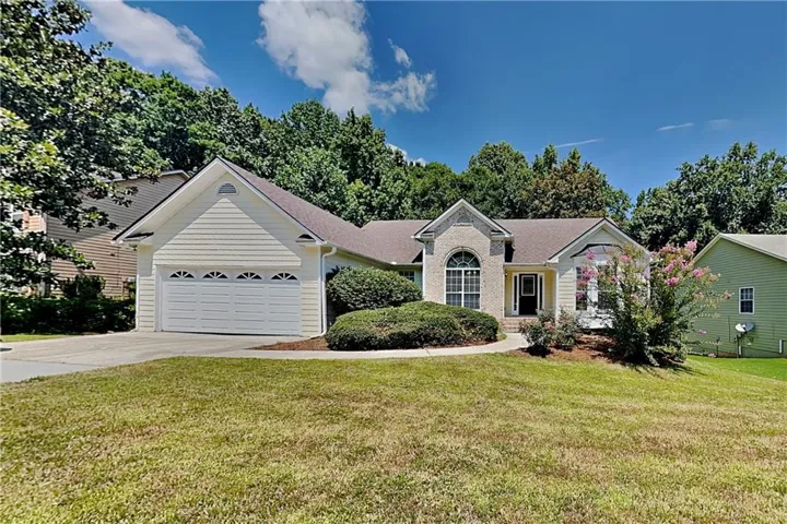 Brick and siding exterior with an attached two-car garage