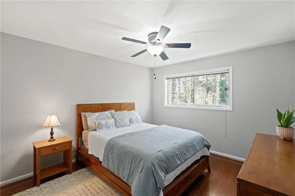 Bedroom with wood-type flooring and ceiling fan