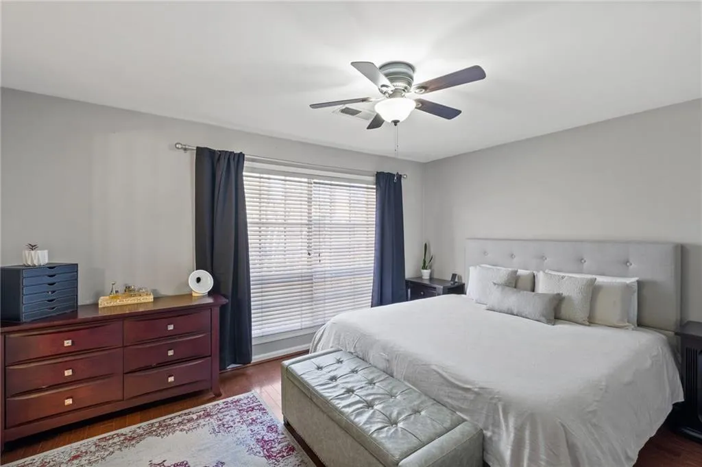 Bedroom featuring dark hardwood / wood-style flooring and ceiling fan