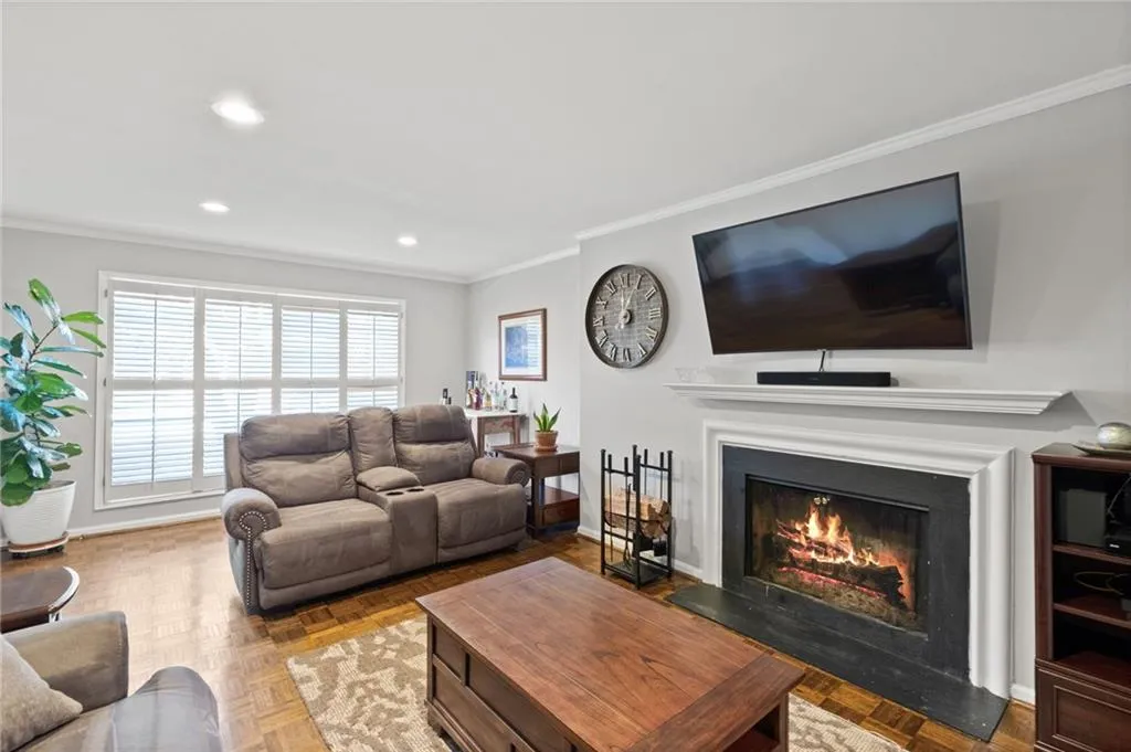 Living room featuring parquet floors and crown molding