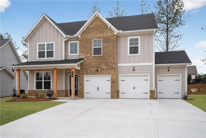 Craftsman house with board and batten siding, a porch, and concrete driveway