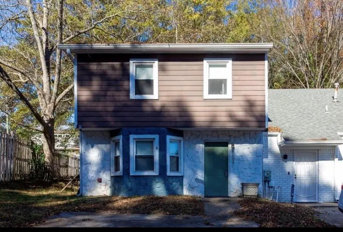 Two-story facade with stone-finish and horizontal panel siding