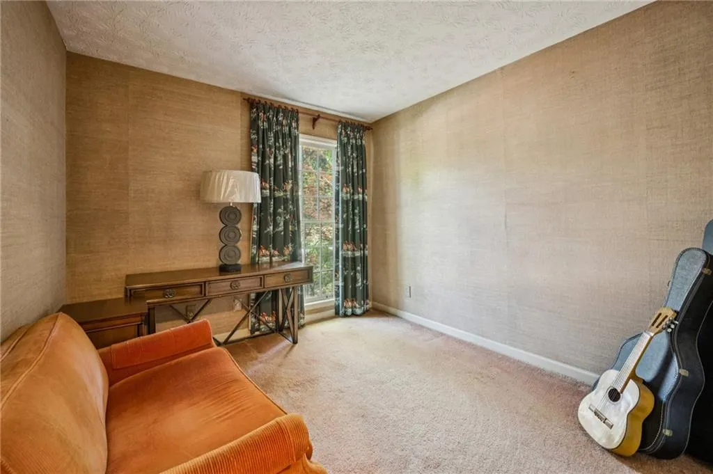 One of the three secondary bedrooms with grasscloth wallpaper.